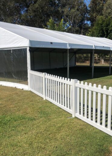 marquee tent on white picket fence
