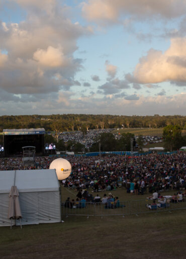 crowd around a marquee tent