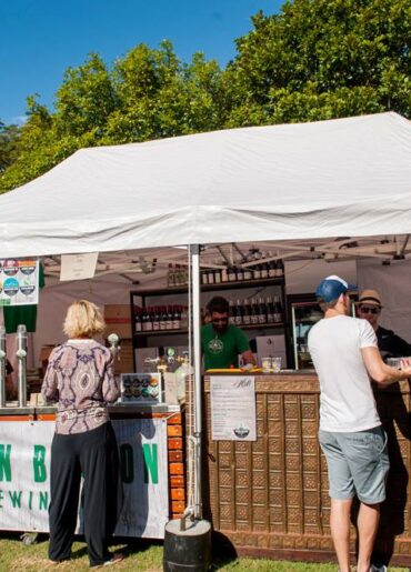 a group of people standing in front of a tent