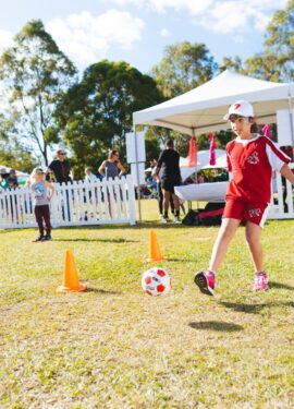a boy kicking a football ball
