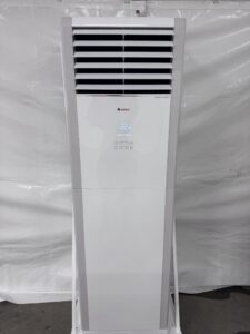 A white standing aircon in front of a white clothe