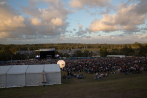 crowd around a marquee tent