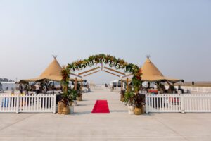 Picket fence and red carpet with arch that says Welcome to Brisbane