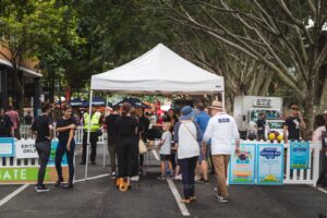 a group of people standing in a parking lot