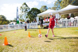 a boy kicking a football ball